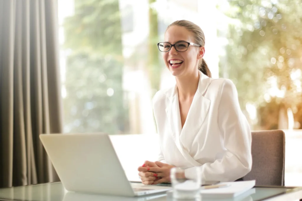 businesswoman sitting at computer laughing