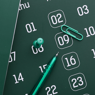 pin and pen on calendar for training virtual team