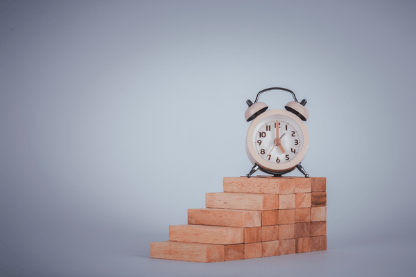 time blocking tips concept- clock on stack of blocks